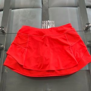 ATHLETA tennis skirt. Size XS. Pretty bright red/orange color.
